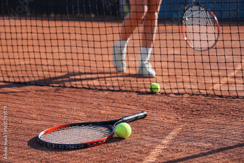 Tennis racket and ball on c...