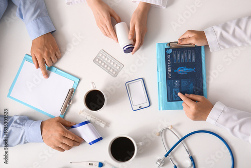 Doctors with patient card, ...