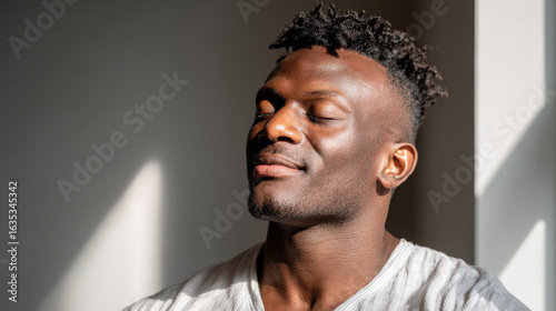 man with closed eyes meditates before his workout enveloped in ultrabright sunlight
