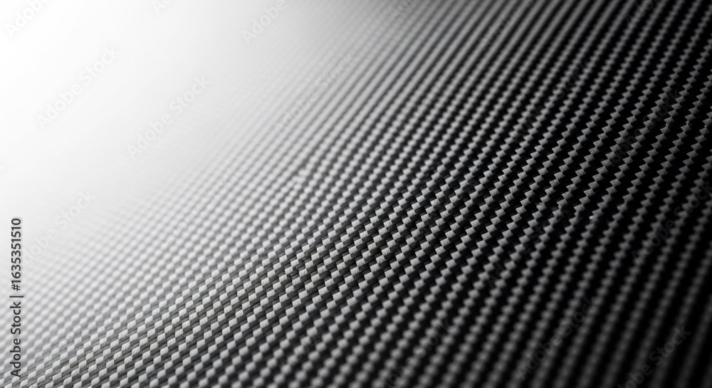Obraz premium Modern background of a carbon fiber composite material. The detailed diagonal weave and dramatic lighting evoke a sense of high performance, strength, and futuristic technology.