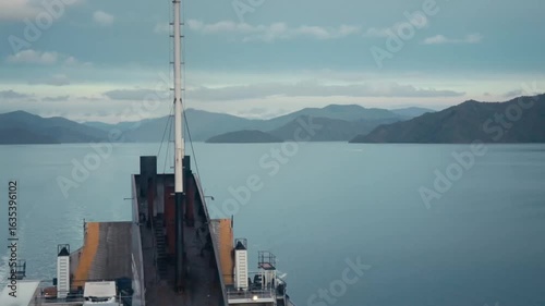 Looking off the back of a moving ship as it leaves the shore