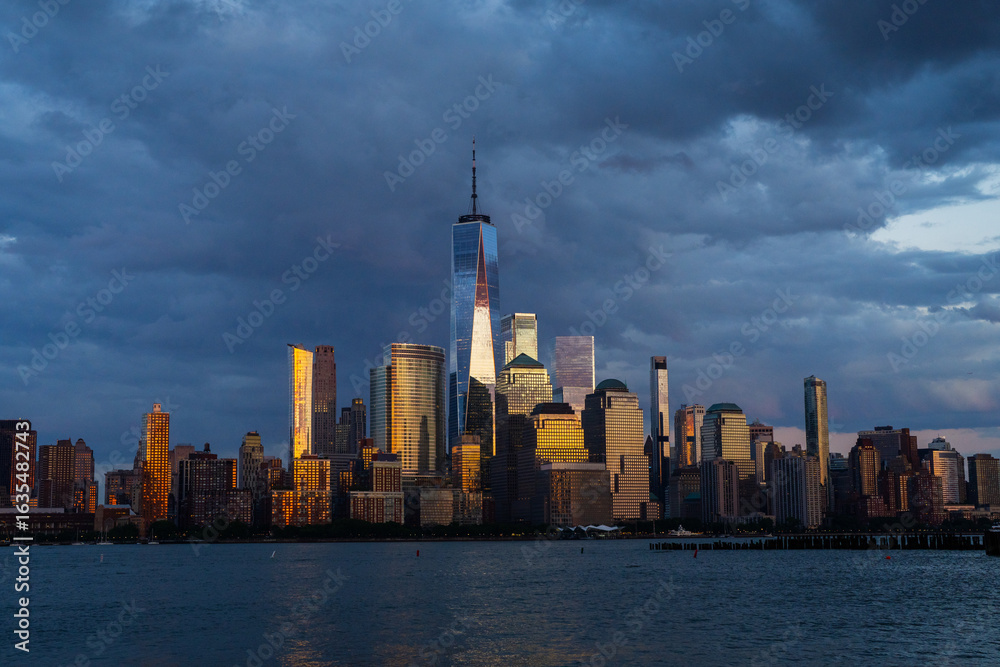 Obraz premium New York City. NYC skyline with towering skyscrapers. Manhattan and Hudson River. Panoramic cityscape of New York. Downtown NYC with landmarks. New York skyline. New York reflecting skyscrapers.