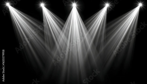 Four bright stage lights converge in a dark setting, creating intense beams of light