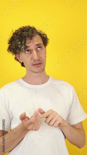 Focused man sequentially counting fingers against a vibrant yellow backdrop—ideal for educational tools, financial analytics, productivity apps, and World Maths Day promotions