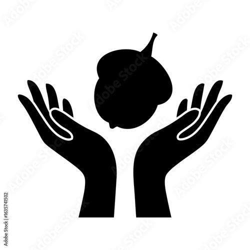 Logo otoño. Silueta de semilla de bellota o nuez con manos con las palmas hacia arriba 