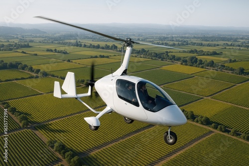 Gyrocopter flying over the vineyards of Sonoma during a clear afternoon