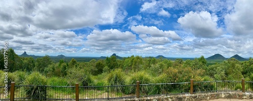 Panoramic view of Glass House Mountains View with Lush Vegetation and Rustic Fence in Queensland, Australia