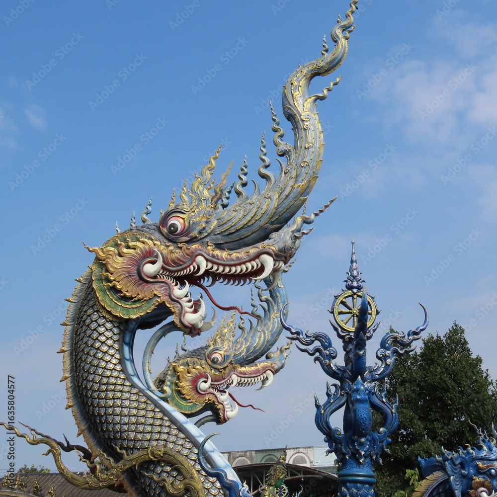 Obraz premium Wat Rong Suea Ten,Ornate architecture, Buddha and figures in the Blue Temple in Chiang Rai, Thailand, Asia