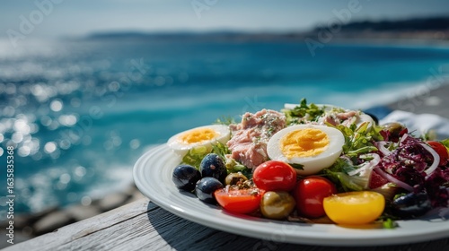 Refreshing French salade niçoise served by the Mediterranean coastline in Nice