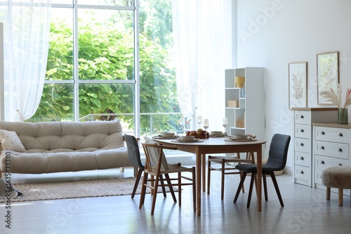 Beautiful table setting  chairs and decor in dining room. Interior design