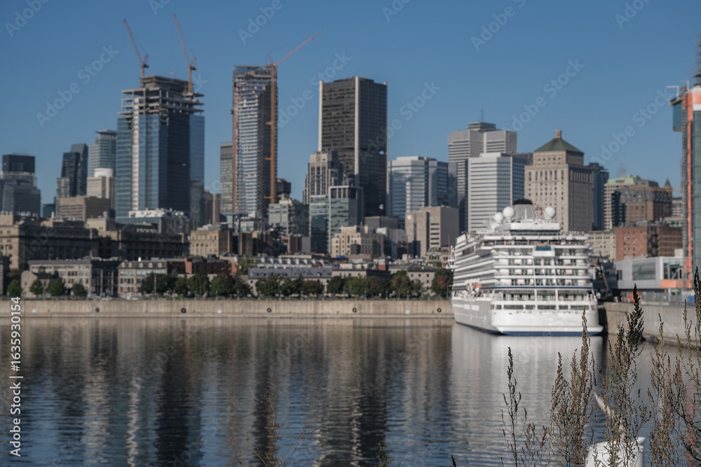 Obraz premium All inclusive luxury yacht cruiseship cruise ship liner Star docked in port St. Lawrence River in Montreal, Quebec Canada during New England Indian Summer cruising
