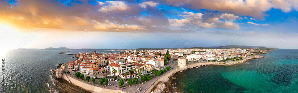 Fototapeta premium Scenic drone view of Alghero's coastline and historic town during a bright summer day