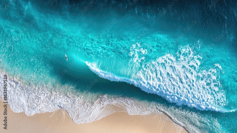 Fototapeta premium Turquoise water waves meeting sandy beach.