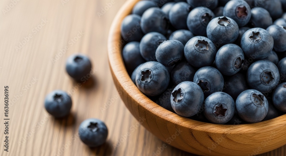 A Rustic Wooden Bowl Brimming with Fresh, Plump Blueberries on a Wood Surface. A Rustic Wooden Bowl Brimming with Fresh, Plump Blueberries on a Wood Surface.