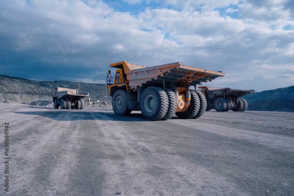 Obraz premium Orange mining truck against background of the slopes of an asbes