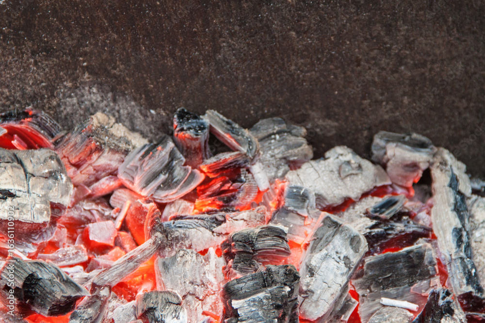 Photo of hot coals. texture of coals on the grill. Edge in the grill Photo of hot coals. texture of coals on the grill. Edge in the grill