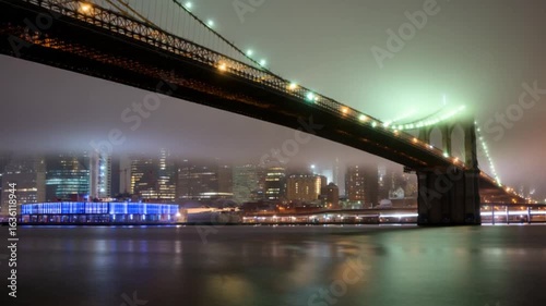 Nighttime Cityscape with Brooklyn Bridge and New York City Skyline — 4K HD Video Footage Download, Illuminated Skyscrapers and Cinematic Urban Reflections