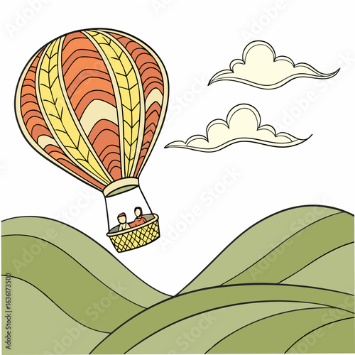 Orange and yellow striped hot air balloon with two people in basket flying over green rolling hills and pale yellow clouds