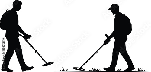 Silhouette of two people using metal detectors on grassy terrain, depicting outdoor search with focus and patience