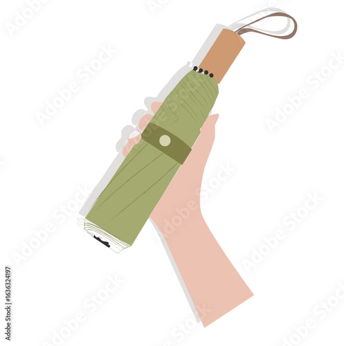 hand holding a folding umbrella.Folded umbrella. Compact collapsible umbrella, rain protection accessory with handle, 