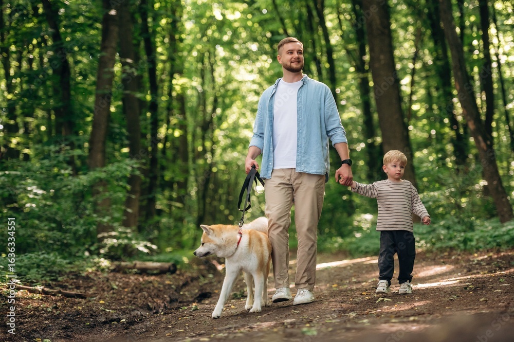 Exploration conception, walking together. Father with son and dog are in the forest Exploration conception, walking together. Father with son and dog are in the forest