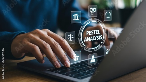 Business professional conducting a pestel analysis on a laptop