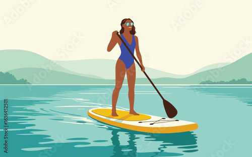 A woman enjoys stand-up paddleboarding on a calm lake during a summer vacation trip