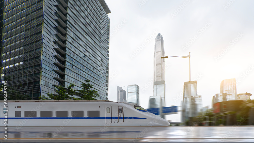 Naklejka premium High-speed train moving through modern cityscape with tall buildings