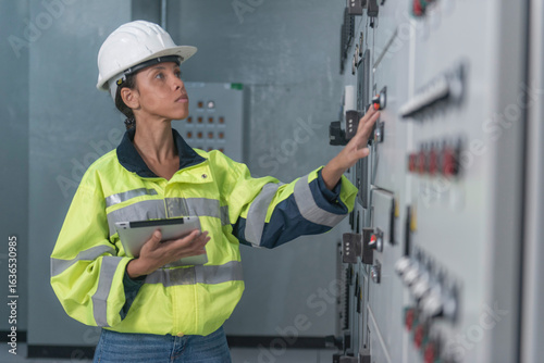 electrician working in a factory. electrician at work. electrician working in a power station. engineer working on the checking status switchgear electrical energy distribution substation.