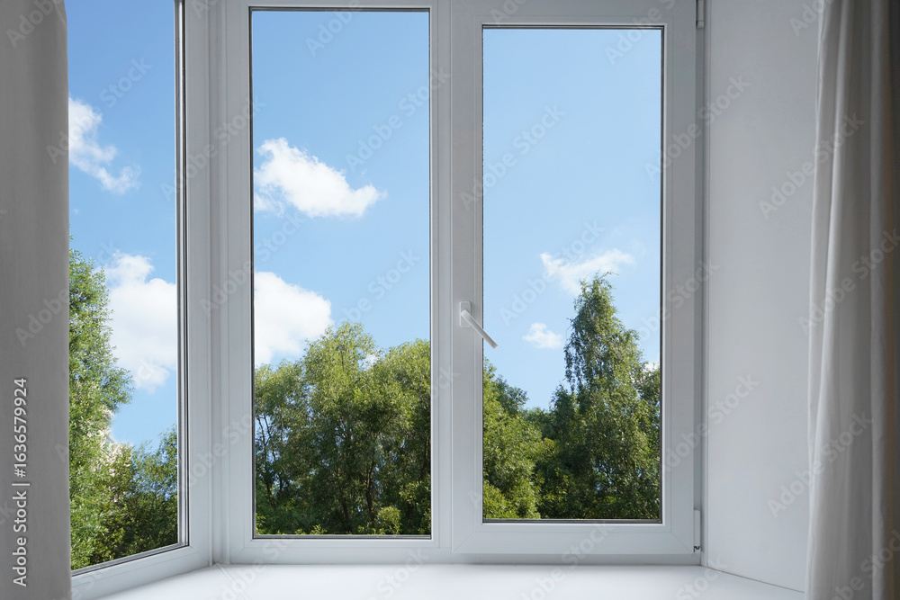 Fototapeta premium View from the window on the garden green trees.