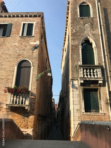 Sunset view over canals and historic houses in Venice.
