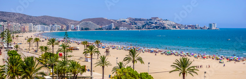 Cullera Bay beach on the Mediterranean Sea, on a sunny day with many umbrellas