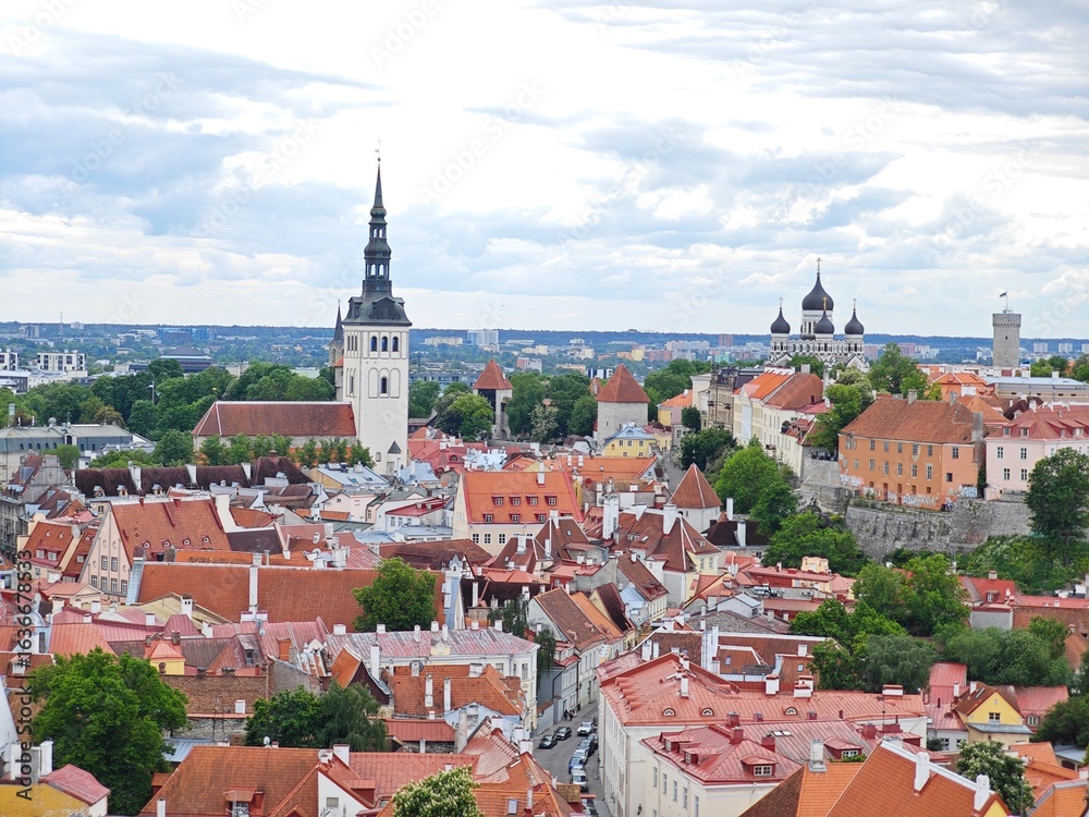 Fototapeta premium Aerial view of Tallinn Old Town, Estonia, showcasing historic medieval architecture, red rooftops, narrow cobblestone streets, and city walls. The image captures the charming and well-preserved herita
