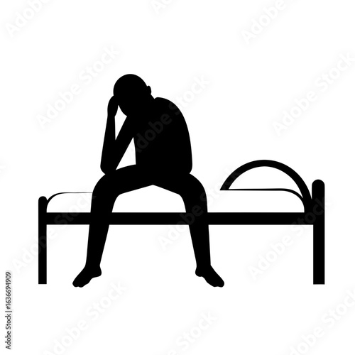 Man sitting on bed in thought silhouette