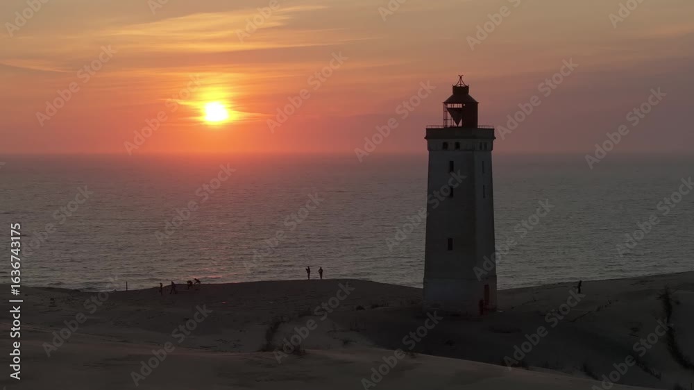 Aerial view of the giant sand dunes with the famous lighthouse on the top of a hill. Rubjerg Knude Lighthouse, , North SeaRubjerg , Sunset at the lighthouse Rubjerg Knude Fyr near Lokken in Denmark. Aerial view of the giant sand dunes with the famous lighthouse on the top of a hill. Rubjerg Knude Lighthouse, , North SeaRubjerg , Sunset at the lighthouse Rubjerg Knude Fyr near Lokken in Denmark.