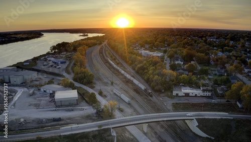 Wallpaper Mural Aerial view of train tracks stretching through the landscape as the sun sets over the Maumee River, Toledo, Ohio, United States. Torontodigital.ca