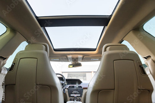 Konstfotografi The interior of a luxury car featuring a sunroof offers an elegant and modern de