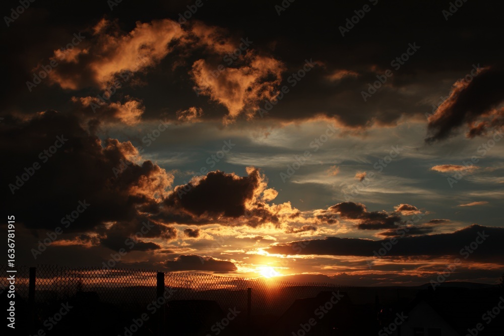 Fototapeta premium Sunset Over Landscape with Clouds
