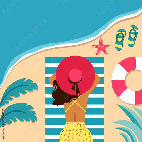 Young girl lies on her stomach  on the beach.