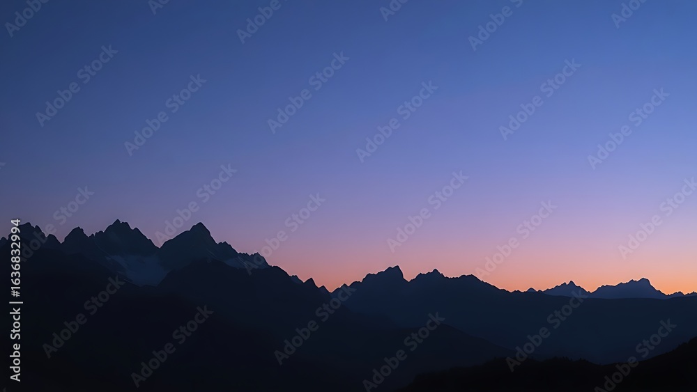 Naklejka premium Majestic mountain peaks silhouetted against a twilight sky with a natural glow.