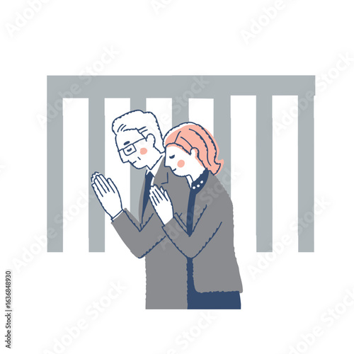 合掌している喪服姿の男女