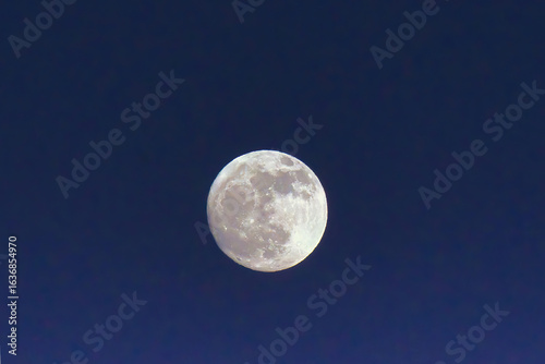 Large bright blue hour full moon.