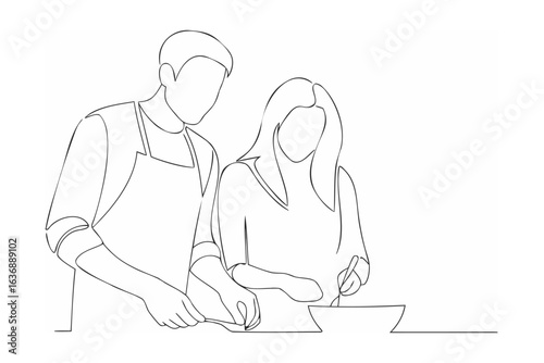 Couple cooking together preparing food kitchen