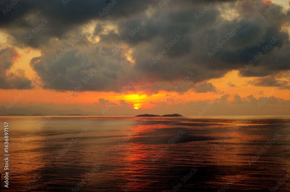Fototapeta premium sunset over the sea with island