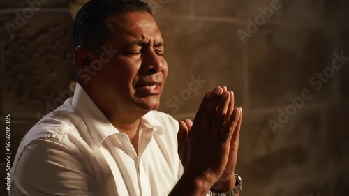 A spiritual man praying with devotion and emotion in a dimly lit ancient church