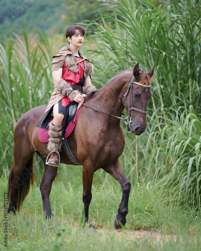 A fantasy ancient warrior riding a horse in the forest with a dramatic action scene.