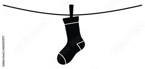 Single black sock hanging on a clothesline
