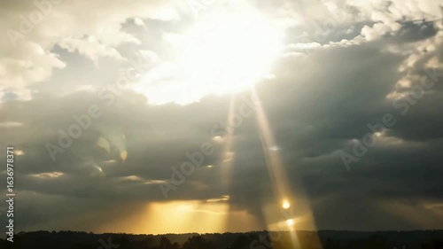 Dramatic sun rays burst through storm clouds creating a powerful and inspiring atmosphere