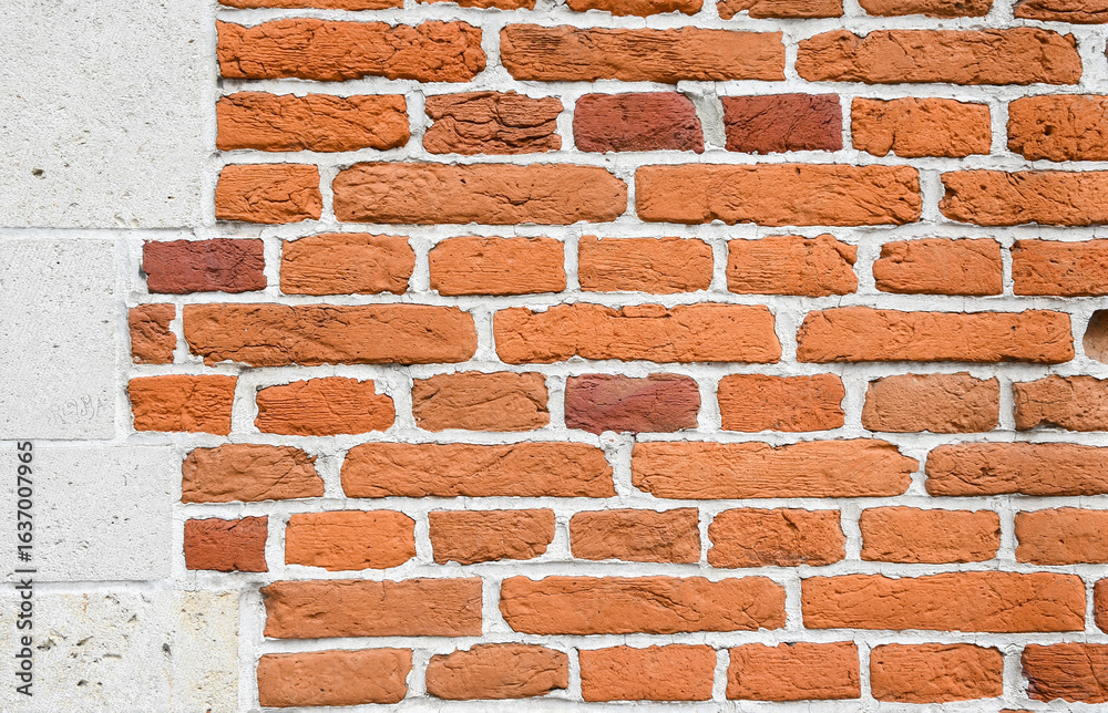 Obraz premium Traditional Flemish orange brick wall with alternating stretcher and header courses in each course, The rough texture of the red clay brick contrasts beautifully with the bright white mortar,