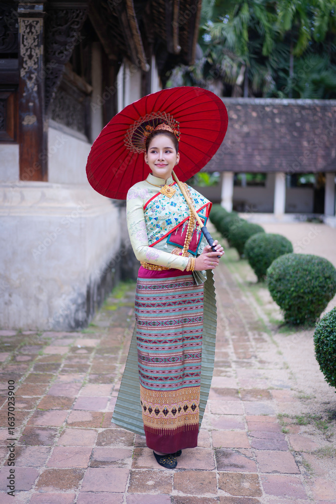Fototapeta premium Pretty Asian Thai woman wearing traditional Thai dress costumes according to Thai culture at the ancient temple in famous tourist attraction in Thailand.